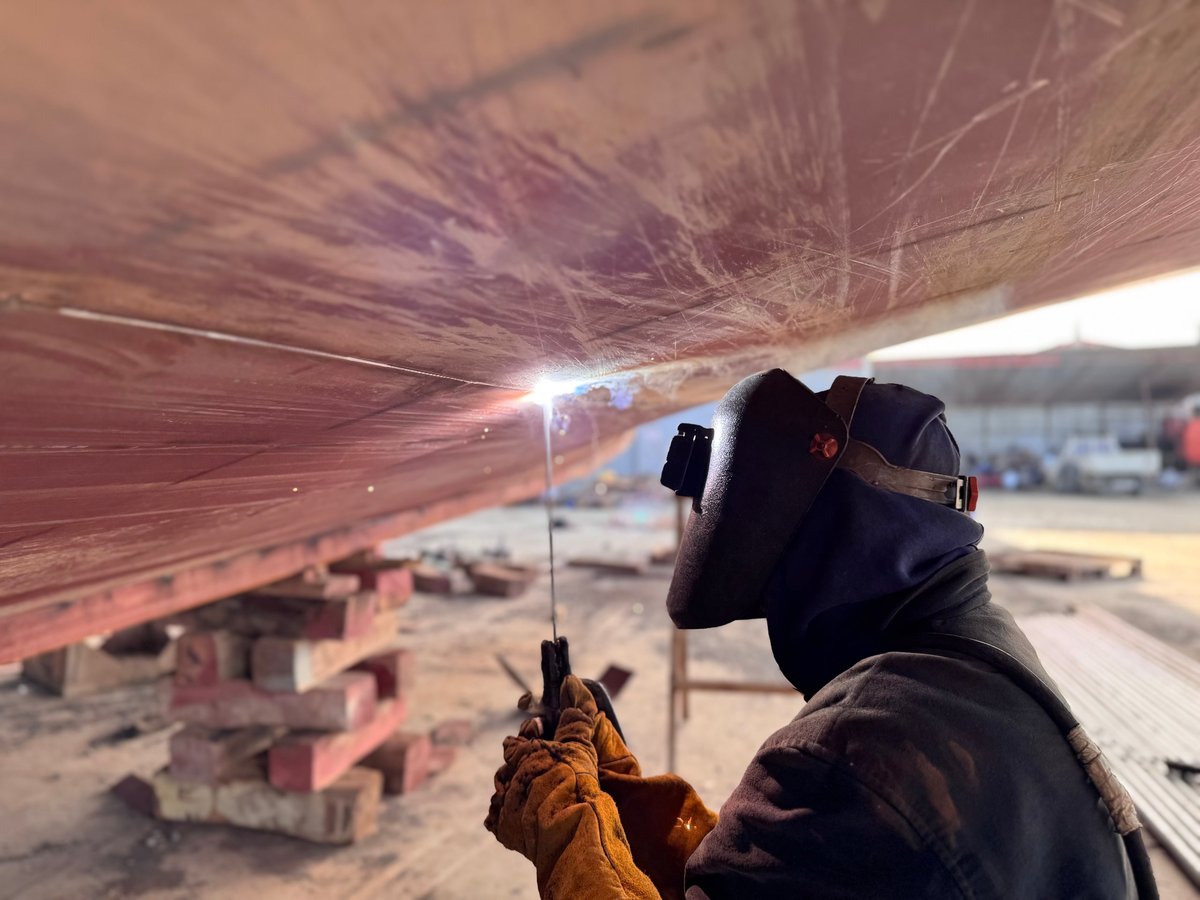 Welder working on a large steel structure